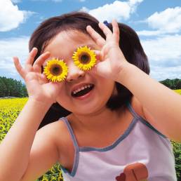 GIrl holding sunflowers as eyes